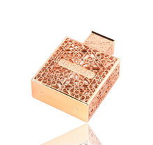 Rose gold Arabian oud perfume bottle with intricate geometric design and 'RAYHAAN' label