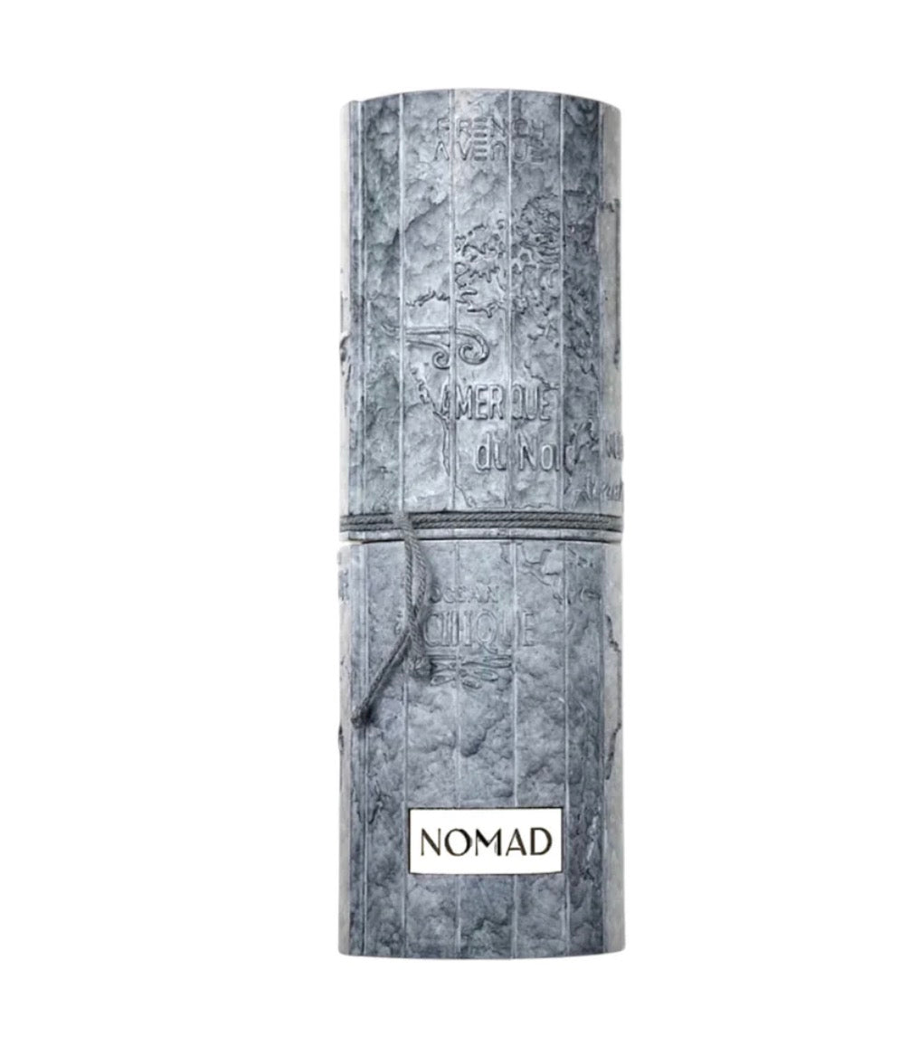 Cylindrical product packaging with 'Nomad' branding on a white background