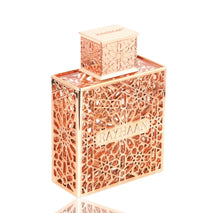 Rose gold Arabian oud perfume bottle with intricate geometric lattice and 'Rayhaan' label