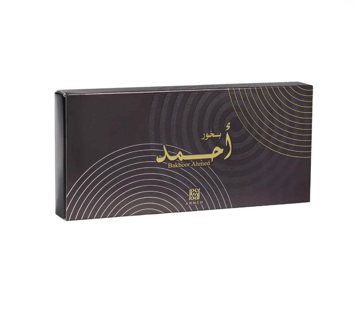 Black Bakhoor incense box with gold Arabic and English text, modern design