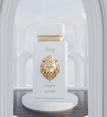 Luxury Arabian oud perfume bottle with gold lion emblem in elegant white arch setting