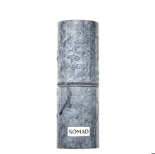 NOMAD Arabian oud perfume grey textured cylindrical packaging with embossed map design