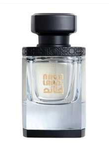 Luxury Arabian oud perfume bottle with black cap and gold Arabic lettering.