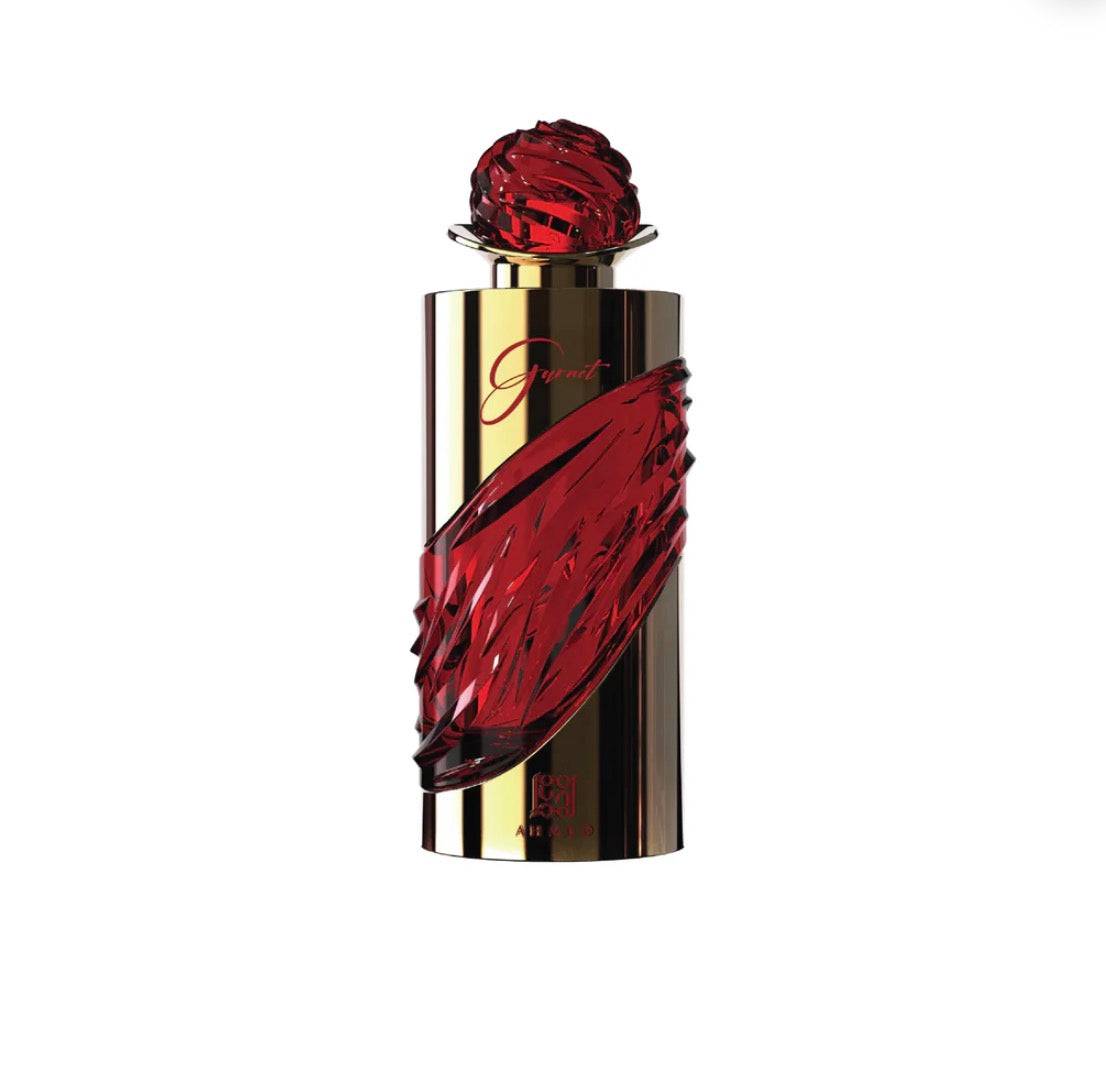 Perfume bottle with red and gold design on a white background