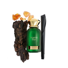 Green gold-capped Ignite Oud perfume bottle with oud wood, amber resin, and leather accent
