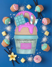 Vanilla Freak perfume bottle with cupcake, vanilla, sugar, chocolate, and candy decorations on blue background