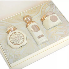 Luxurious Arabian oud perfume gift set with ornate white and gold bottles in decorative box
