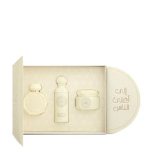 Luxury Arabian oud perfume gift set with three elegant cream-colored bottles in ornate box
