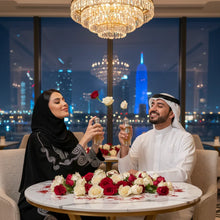 Elegant couple enjoying Arabian oud perfume at a rose-adorned table, city view in background