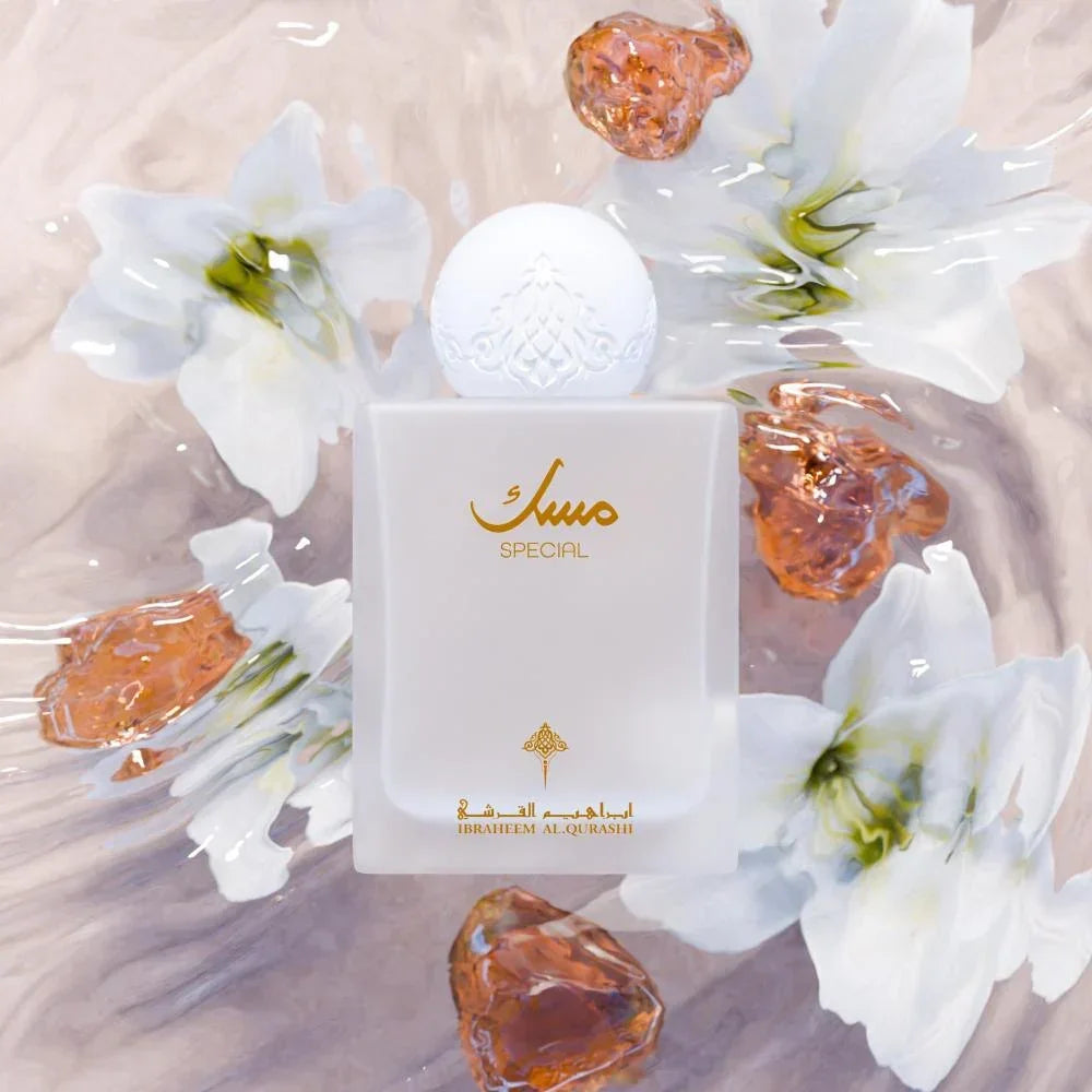Elegant white Arabian perfume bottle labeled 'Special' with gold Arabic script, surrounded by white lilies and amber-like resin gems.