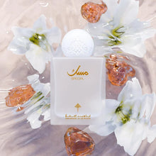 Elegant white Arabian perfume bottle labeled 'Special' with gold Arabic script, surrounded by white lilies and amber-like resin gems.