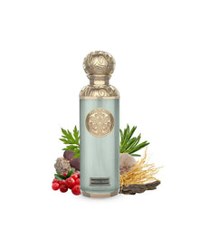 Elegant oud perfume bottle with gold accents, surrounded by berries, herbs, roots, and woody elements.