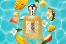 Mango Punch Arabian perfume bottle with mango, pineapple, peach, and floral notes by a pool