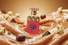 Luxury caramel oud perfume bottle with gold cap, surrounded by caramel, chocolate, and popcorn.