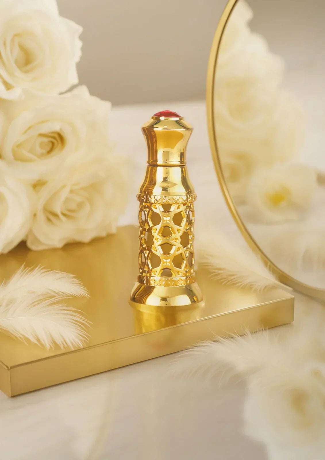 Luxury gold Arabian oud perfume bottle on gold tray with white roses and feathers, Royal Oud