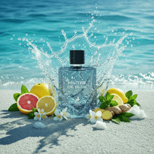 Maître De Blue perfume bottle on beach with citrus fruits, ginger, and ocean splash