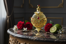 Luxury Arabian oud perfume bottle with gold and red accents, surrounded by roses, citrus, and blossoms on a marble table