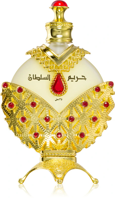 Luxury Arabian oud perfume bottle with gold and red jeweled accents, ornate design