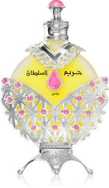 Elegant Arabian oud perfume bottle with ornate silver and pink detailing, yellow liquid inside