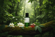 Green oud perfume bottle with florals and spices on a mossy log in a lush forest setting