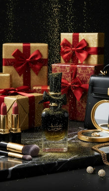 Luxury perfume bottle with gold glitter, surrounded by gift boxes, lipsticks, and makeup accessories.