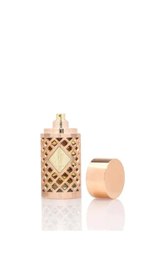 Luxury Arabian oud perfume bottle with gold lattice design and removable cap on white background.