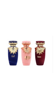 Three luxury Arabian oud perfume bottles in blue, pink, and burgundy with gold accents.