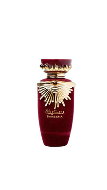 Luxury red velvet Arabian oud perfume bottle with gold decorative accents and Sakeena label