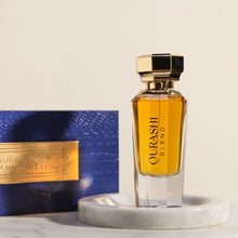 Luxury Qurashi Blend Arabian oud perfume in gold-capped bottle with blue gift box