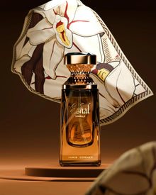 Eshal Vanilla Eau de Parfum bottle with ornate cap and floral background