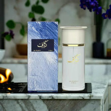Luxury Arabian oud perfume bottle and blue box with gold Arabic script on marble countertop. Kaaf 