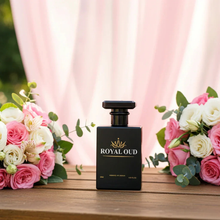 Luxury Royal Oud perfume bottle on wooden table with pink rose flower bouquets