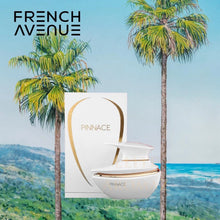 Pinnace perfume bottle and box displayed outdoors with palm trees and ocean in background
