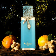 Luxury blue Vulcan Feu perfume bottle with gold snake detail, surrounded by ginger and fruits outdoors