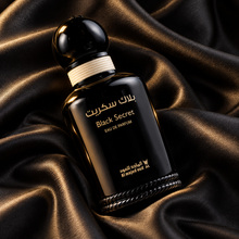 Overhead diagonal view of Black Secret Eau de Parfum bottle on black satin