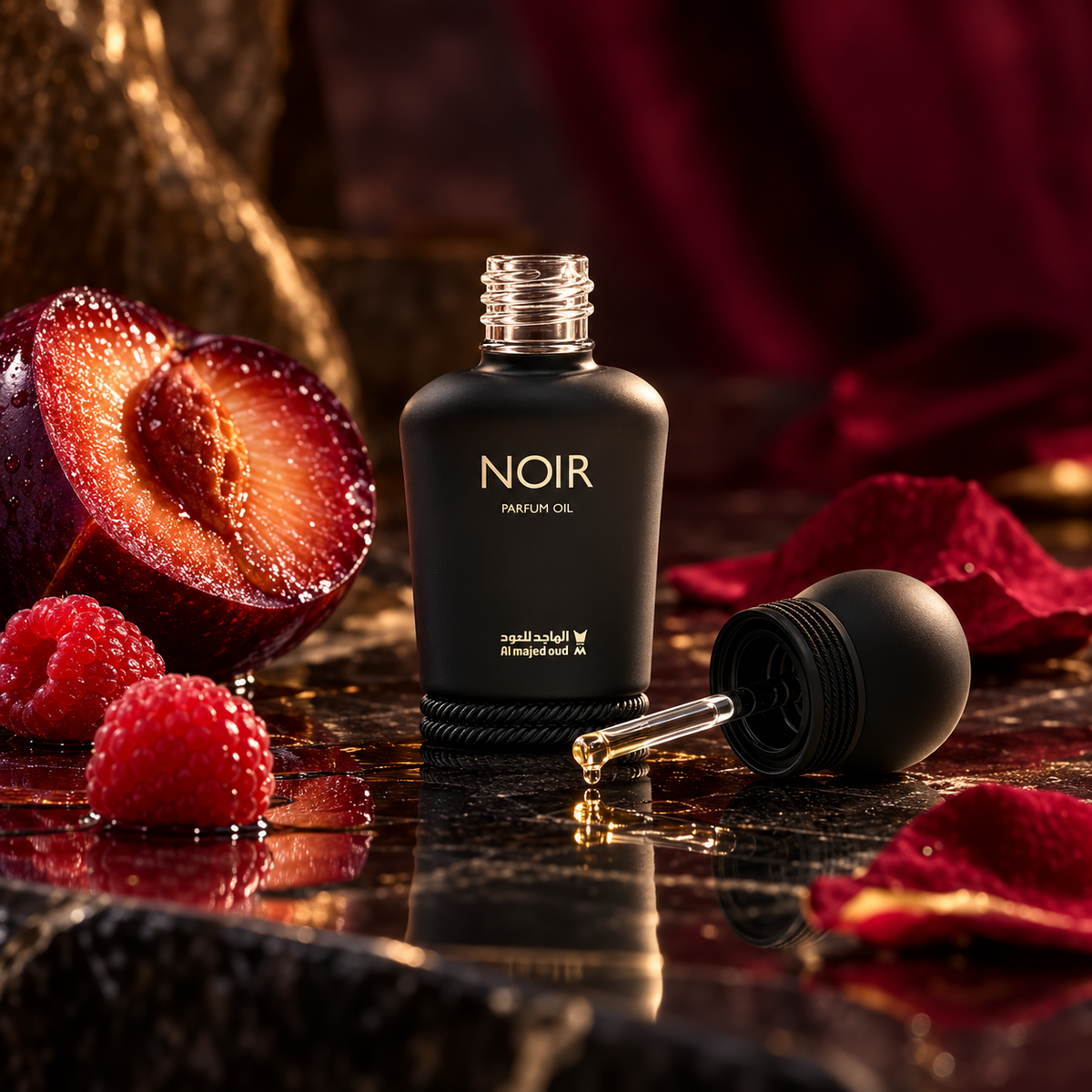 Open Noir perfume oil bottle and glass dabber with plum raspberry and rose petals in cinematic warm light