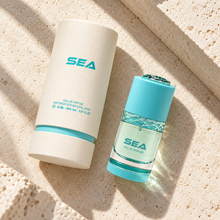 Al Majed Oud Sea 15ml bottle and presentation tube photographed overhead on limestone
