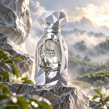 Marwa Extrait silver faceted bottle on stone overlooking a misty tea garden; design may vary