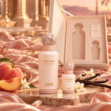 Candy Musk EDT and perfume oil beside their open fitted gift box with peach and vanilla props