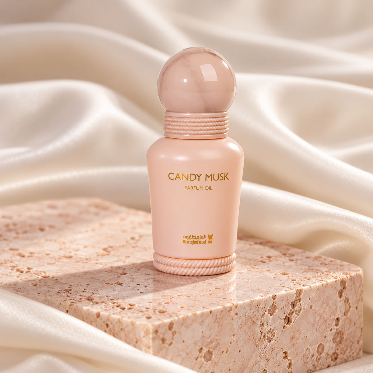 Candy Musk 15ml perfume oil bottle on blush travertine with ivory silk