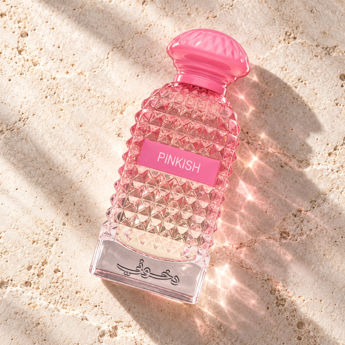 DKHONI Pinkish 100ml Eau de Parfum — overhead bottle composition