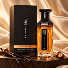 Amjad Mystery bottle and box with vanilla pods and hazelnuts against cream silk