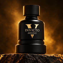 Invicto Absolu black and gold bottle on charcoal stone with amber lighting