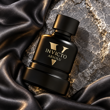 Overhead Invicto Absolu black bottle on charcoal silk and grey marble