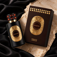 Les Extraits Absolus Shadow 60ml bottle and matching brown box photographed overhead on silk and stone