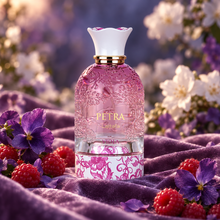 Lattafa Petra Viola perfume on purple velvet surrounded by raspberries, violets and softly lit white flowers