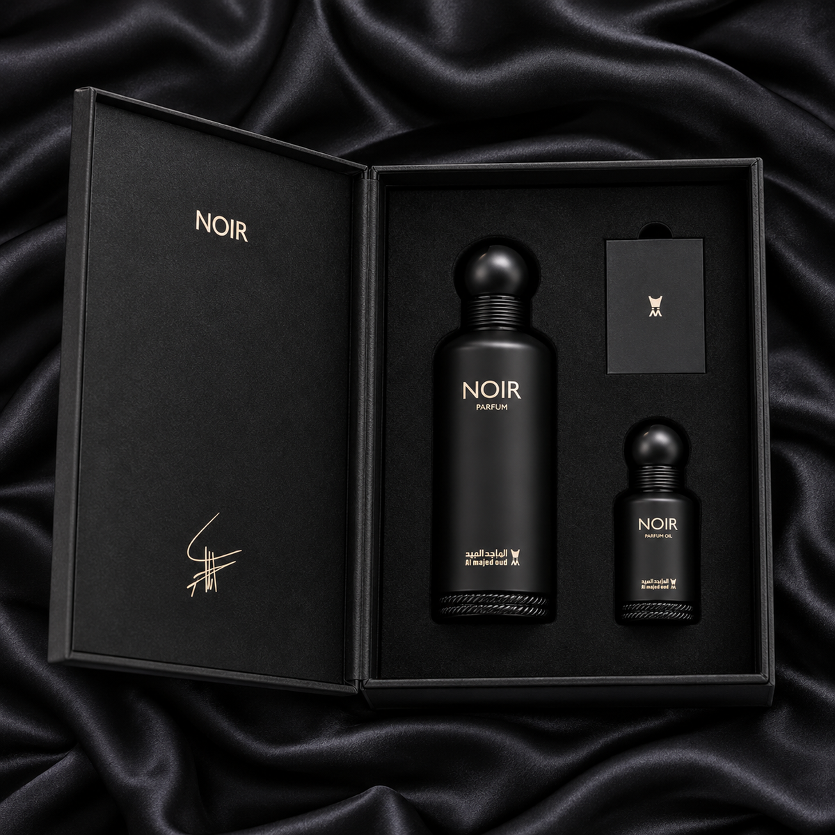 Overhead view of Noir 150ml Parfum and 15ml perfume oil in their original open black fitted gift box