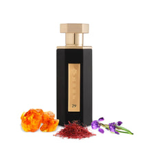 Black and gold perfume bottle with amber, saffron, and purple flower accents