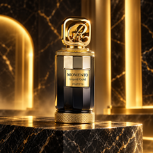 Momento Liquid Gold bottle on black marble with gold architectural light
